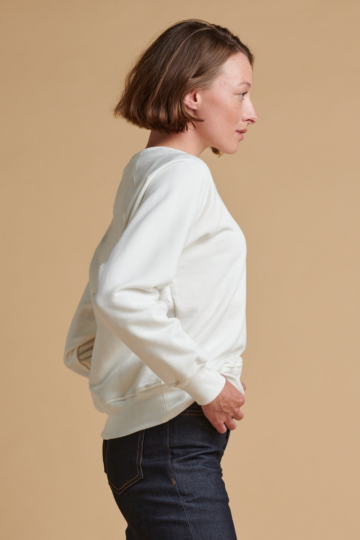 The side of female wearing raglan sweatshirt plastic free in bone.