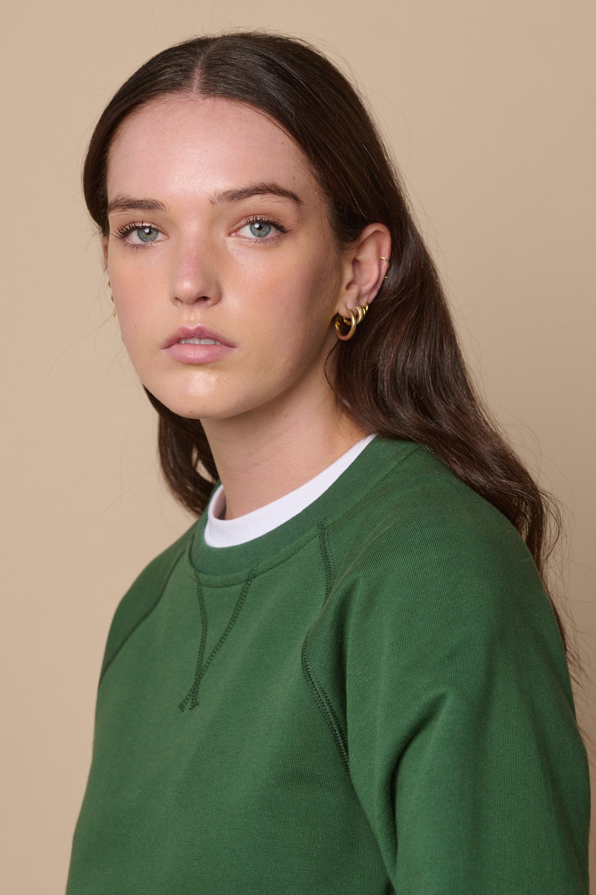 Portrait of female wearing raglan sweatshirt in bottle green