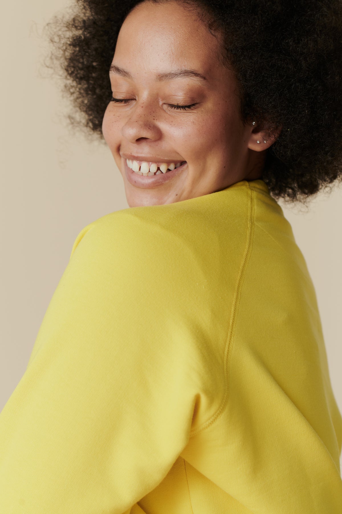 
            Portrait of female wearing raglan sweatshirt in canary yellow