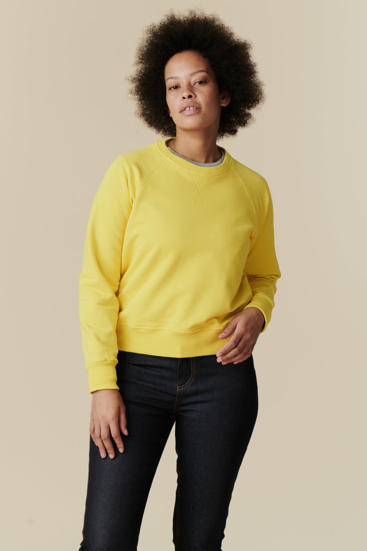 
            Knee up image of female wearing raglan sweatshirt in canary yellow