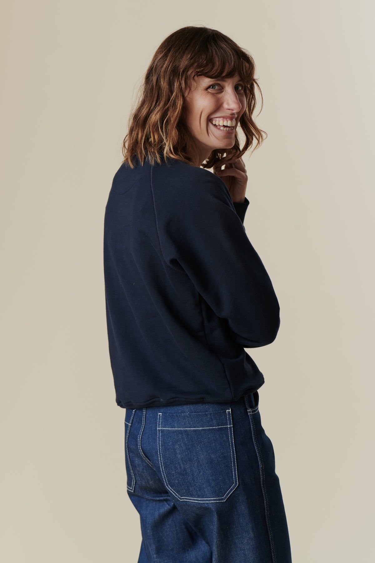 Female wearing women's raglan sweatshirt in navy