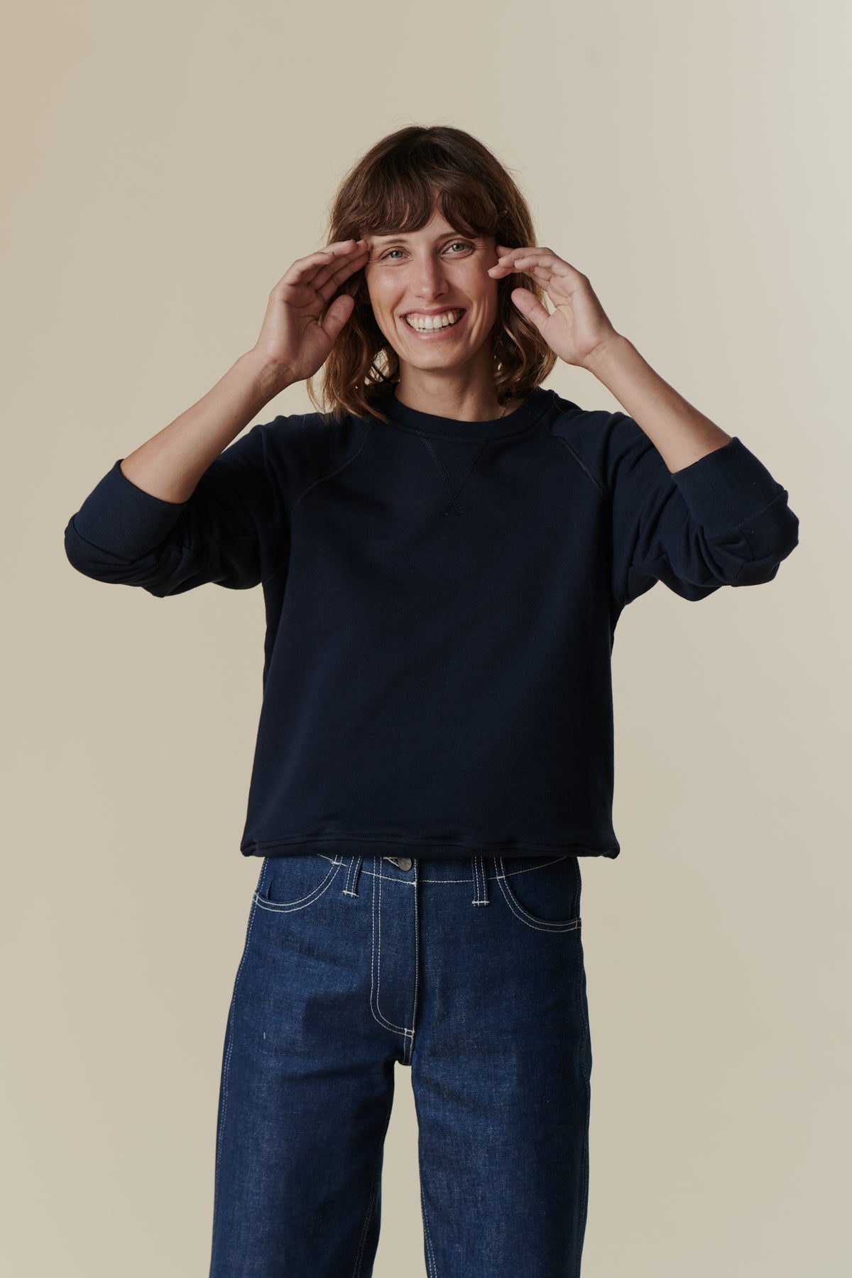 Female wearing women's raglan sweatshirt in navy