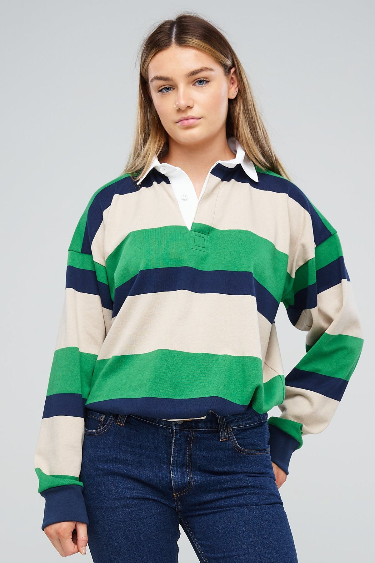 
            Female wearing rugby shirt ecru navy bottle stripe tucked into jeans