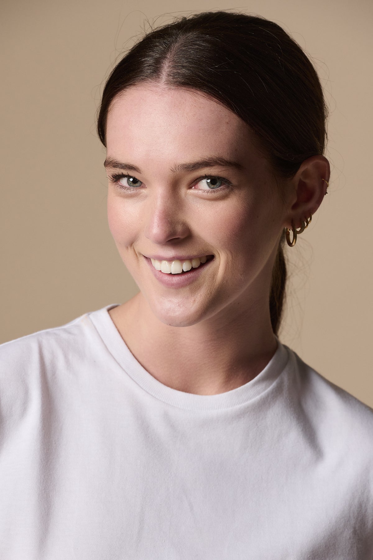 
            Portrait of smiley female wearing short sleeve t shirt plastic free in white