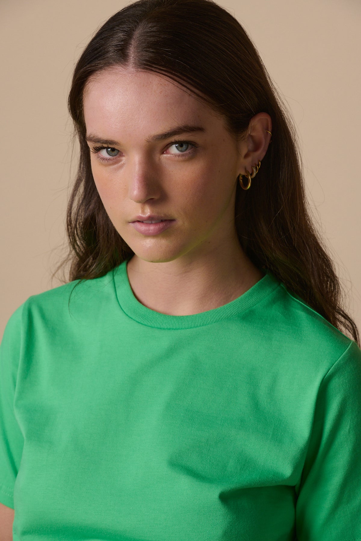 
            Portrait of brunette female wearing short sleeve crew neck t shirt in apple green