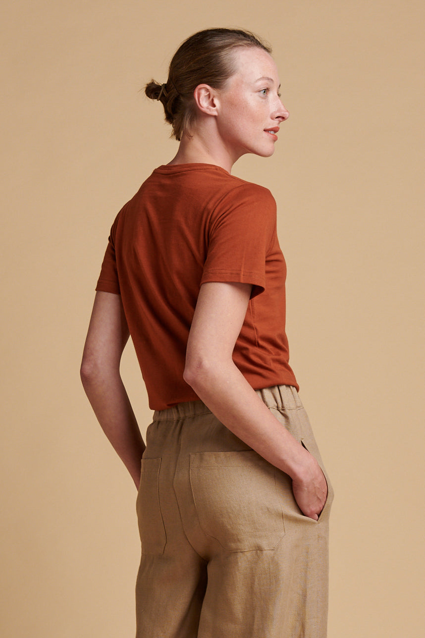 The back of female wearing short sleeve, crew neck t shirt in cinnamon.