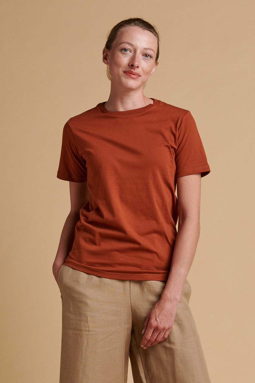 Female wearing short sleeve, crew neck t shirt in cinnamon.