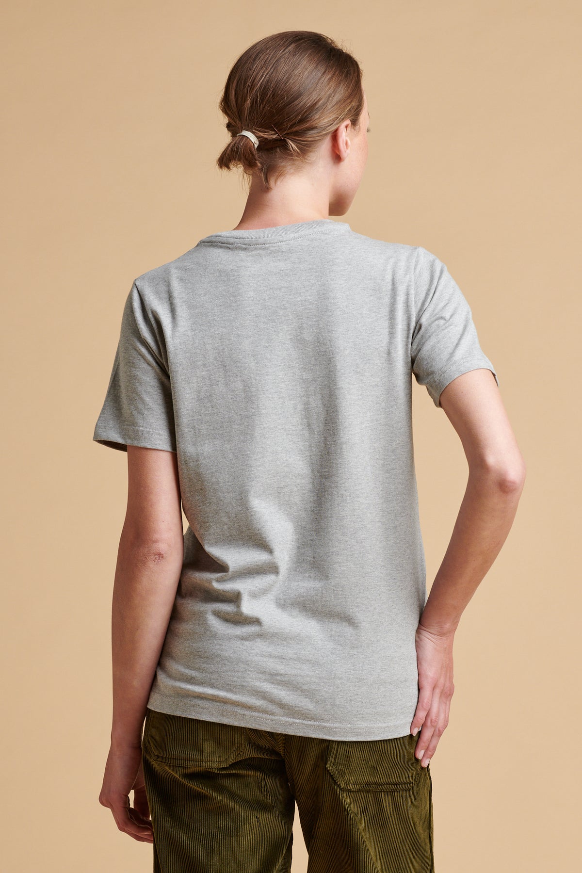The back of female wearing short sleeve t shirt in grey marl.