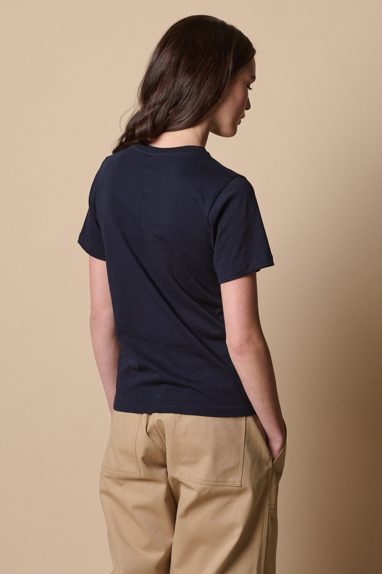 Back of female wearing short sleeve t shirt in navy