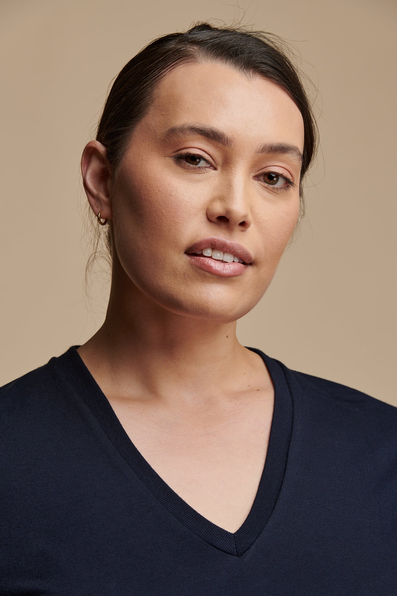 Portrait of female with hair wearing short sleeve v neck t shirt in navy 