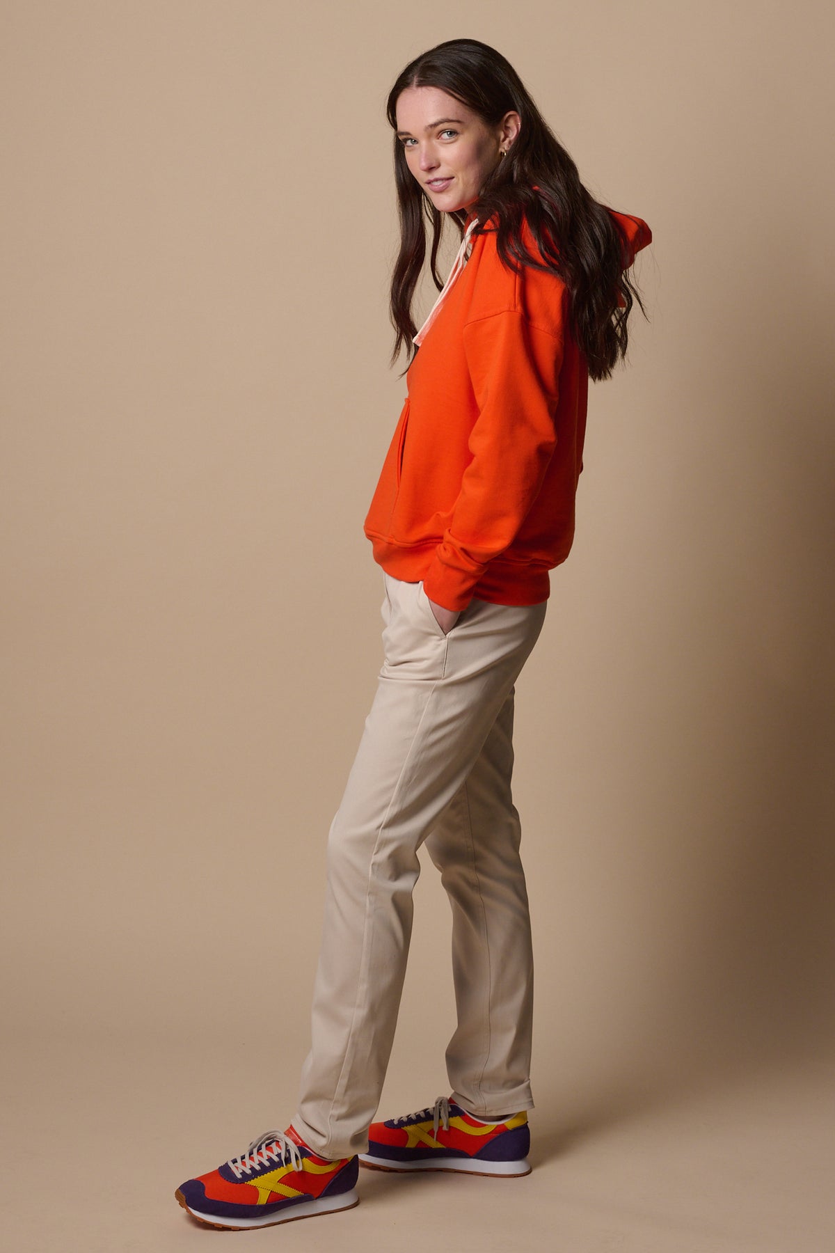 Side of female wearing slim stretch chinos in light stone