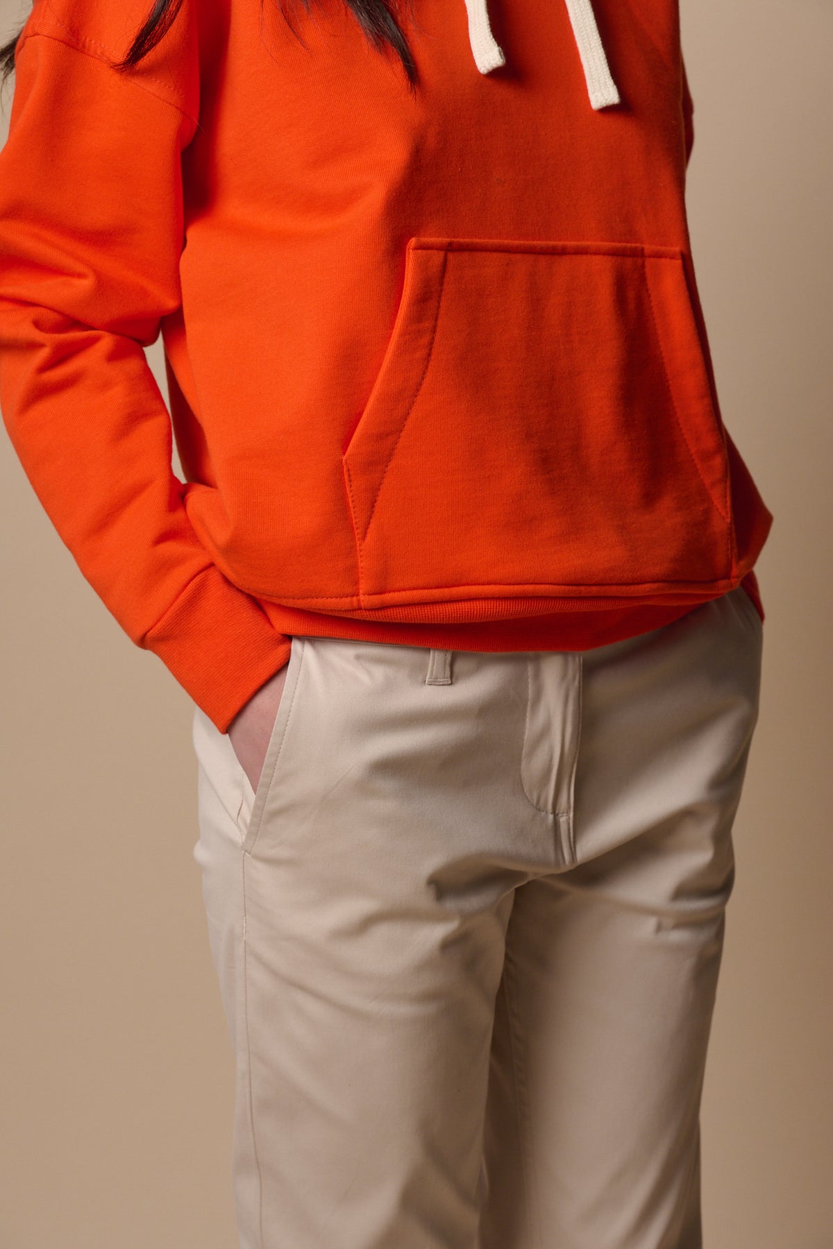 Female with hand in front pocket of slim stretch chino in light stone