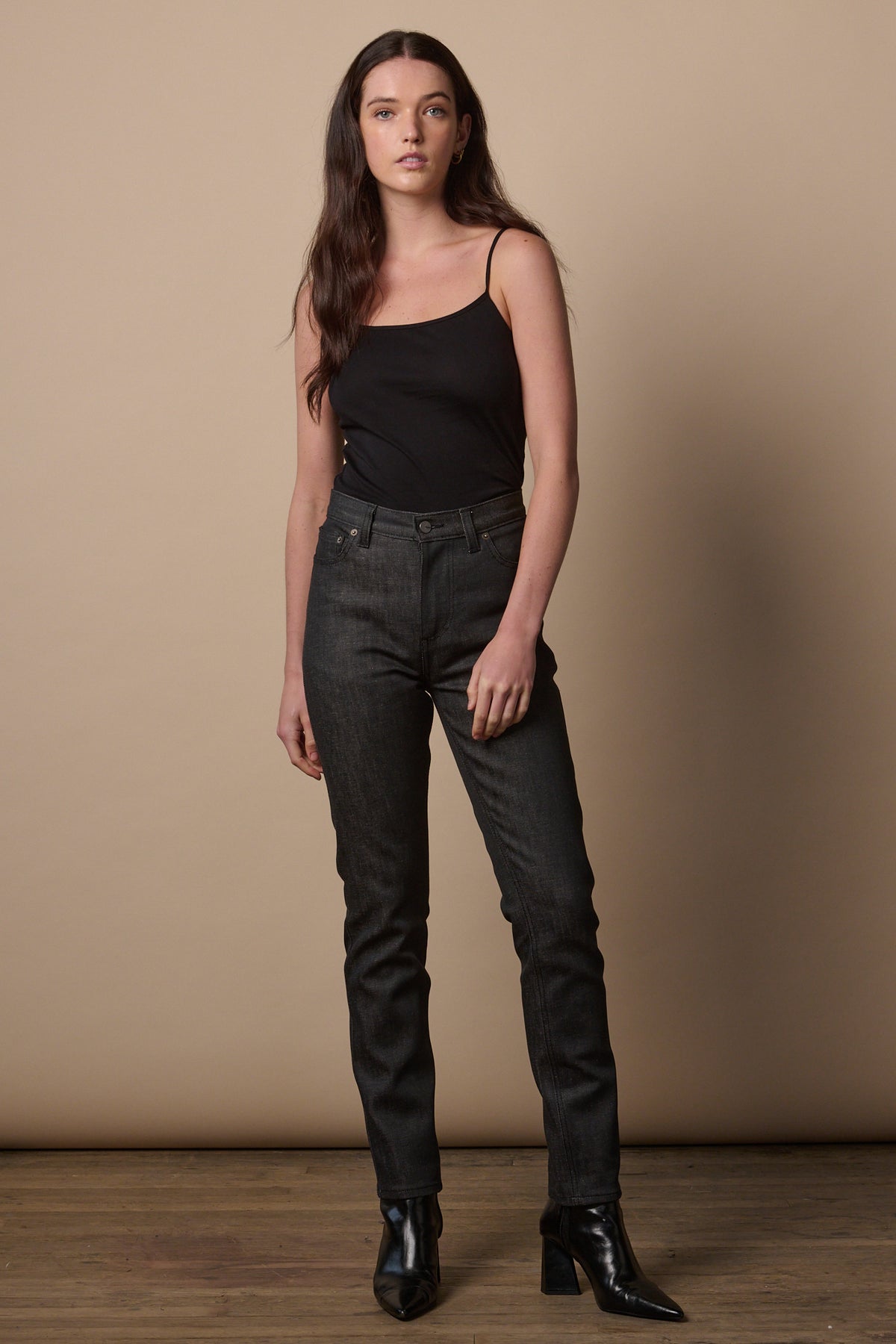 
            Full body image of female wearing high waist jeans in black with black camisole tucked in