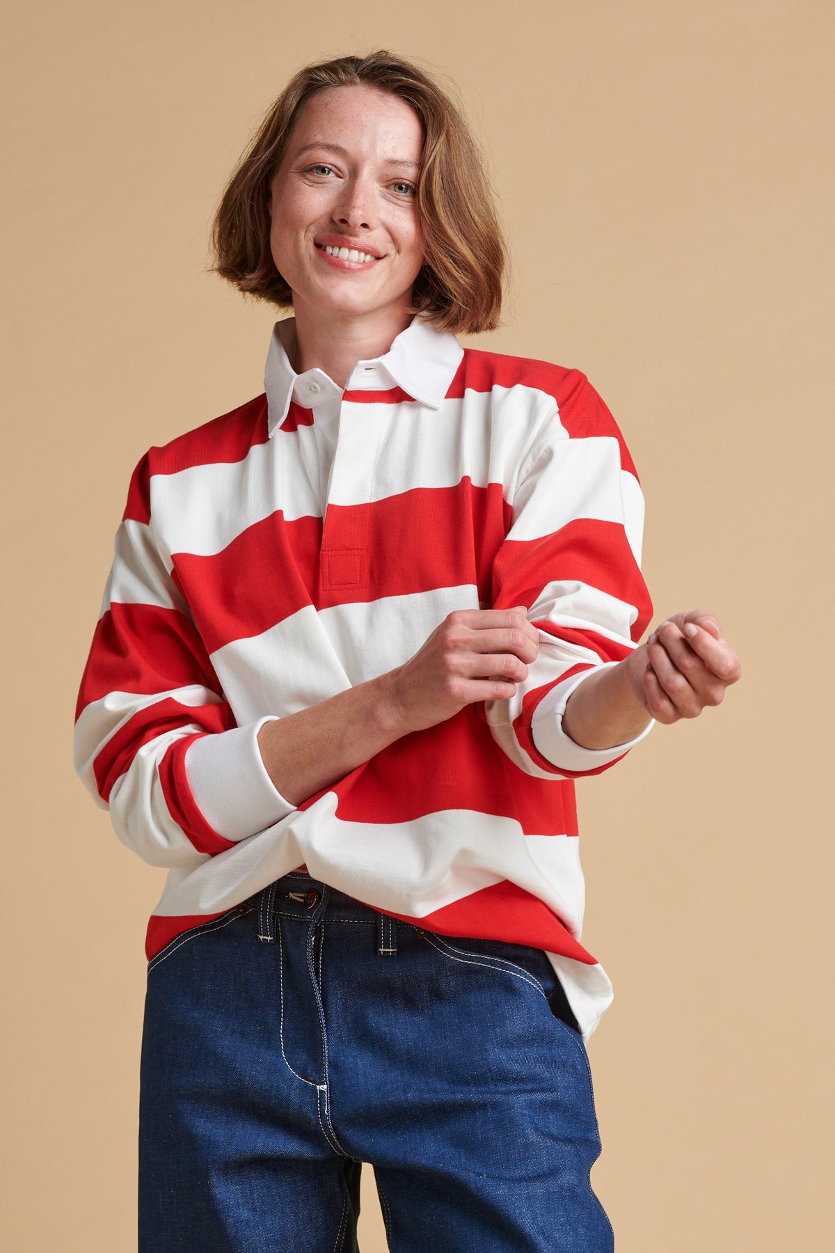 Female wearing unisex stripe rugby shirt in red and white.