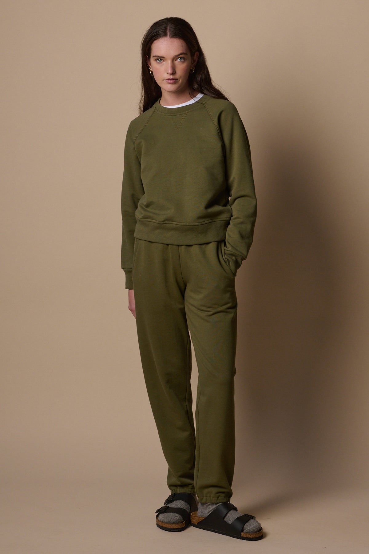 full boy image of the front of female wearing matching olive sweatpants and sweatshirt set