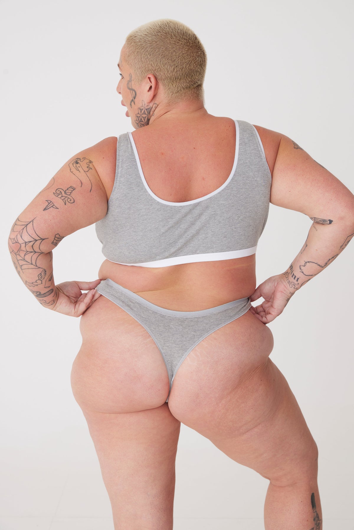 tattooed, white female wearing grey thong