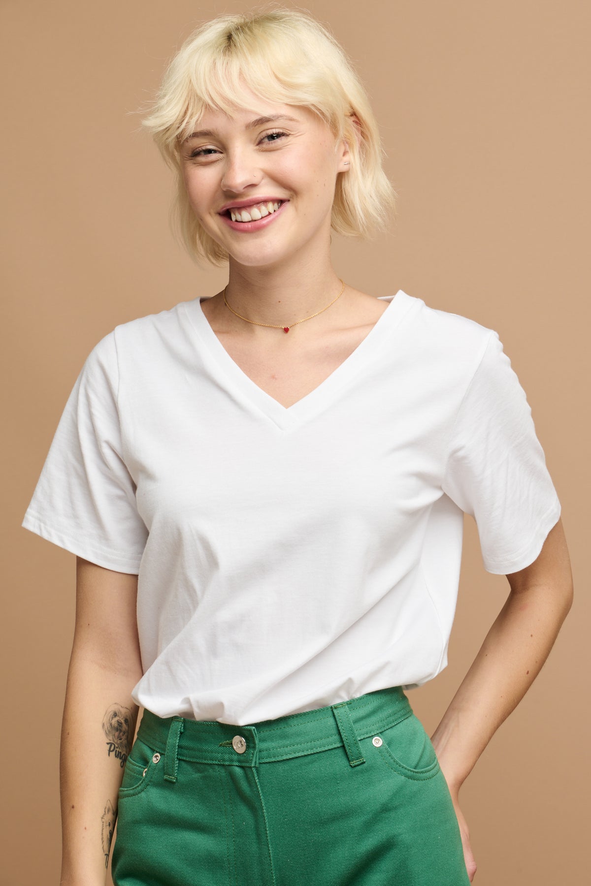 smiley female wearing community clothing v neck short sleeve t shirt in white