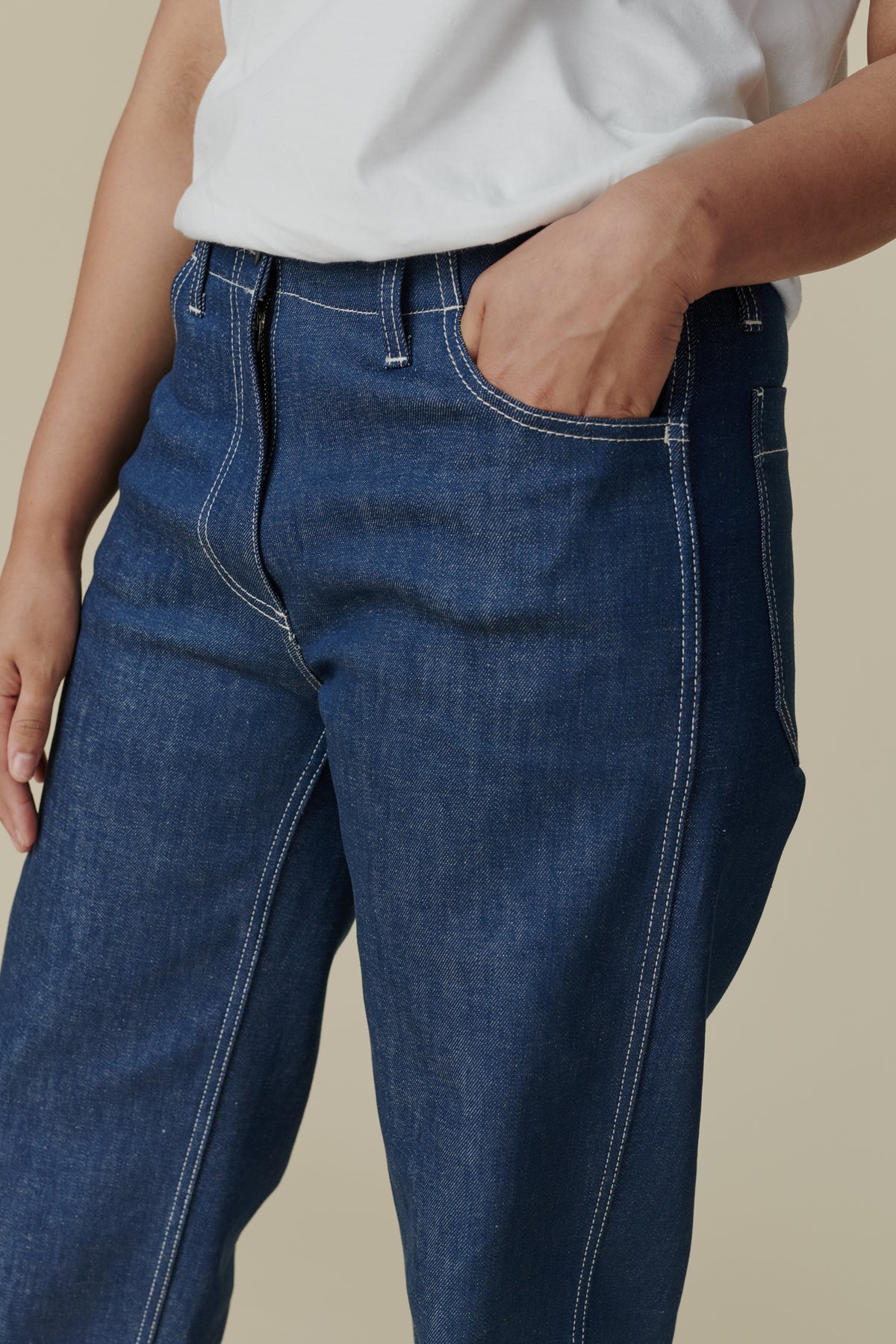 
            Female wearing white crew neck white t shirt paired with women&#39;s work jean in Blue, white contrast stitching, belt loops and front pocket detail