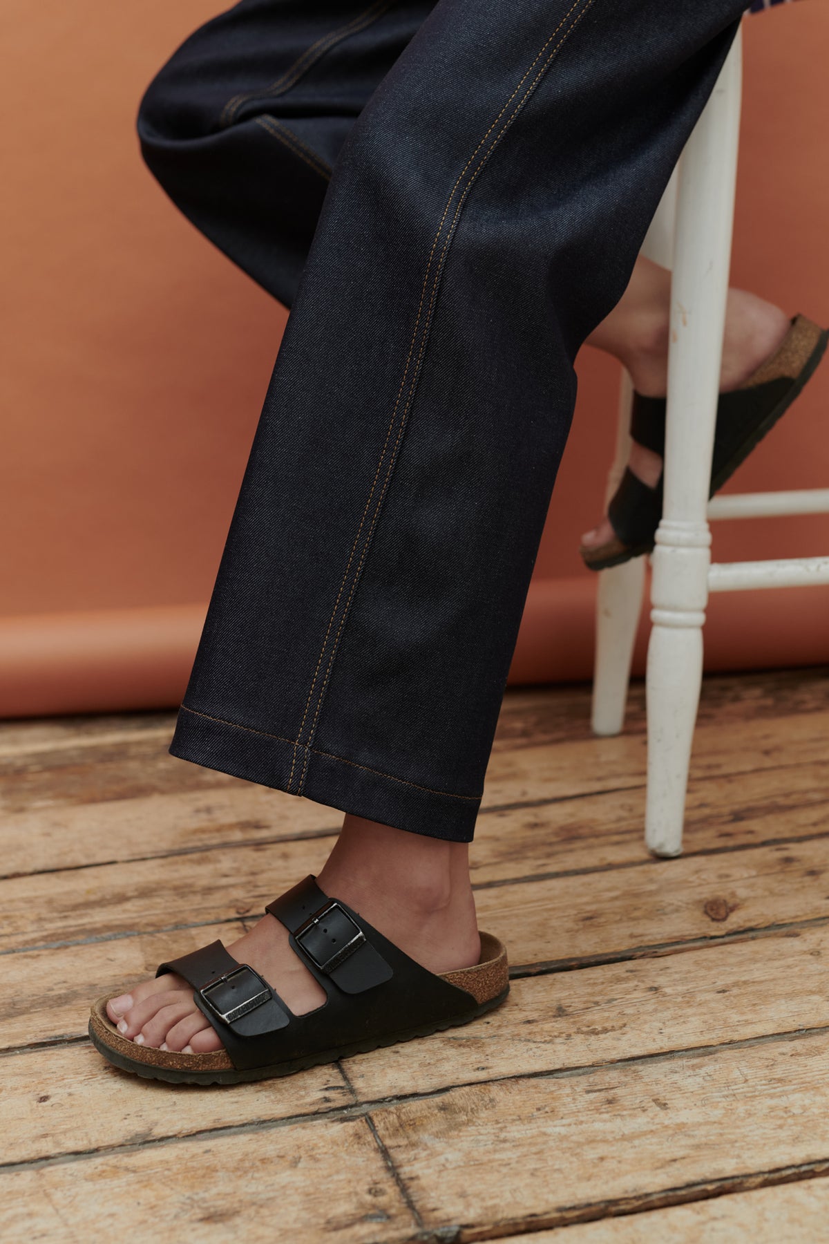 Thigh down image of female legs wearing work jean in indigo.