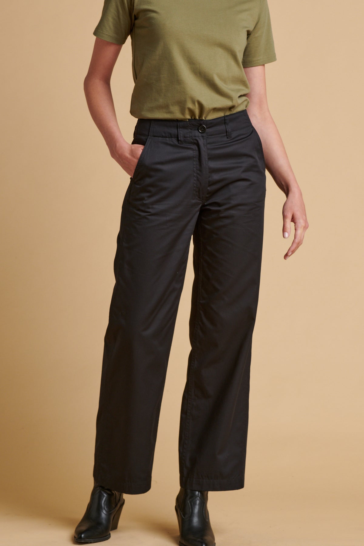 Female wearing lightweight work trousers in black.