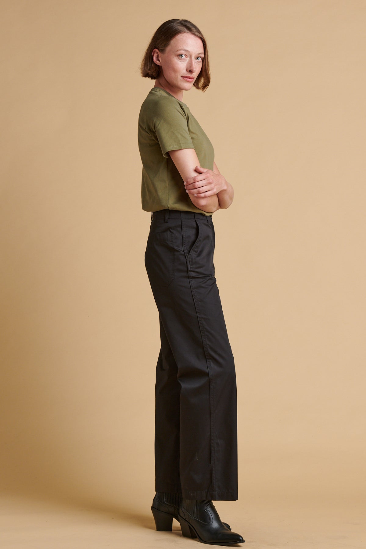 Female wearing lightweight work trousers in black.