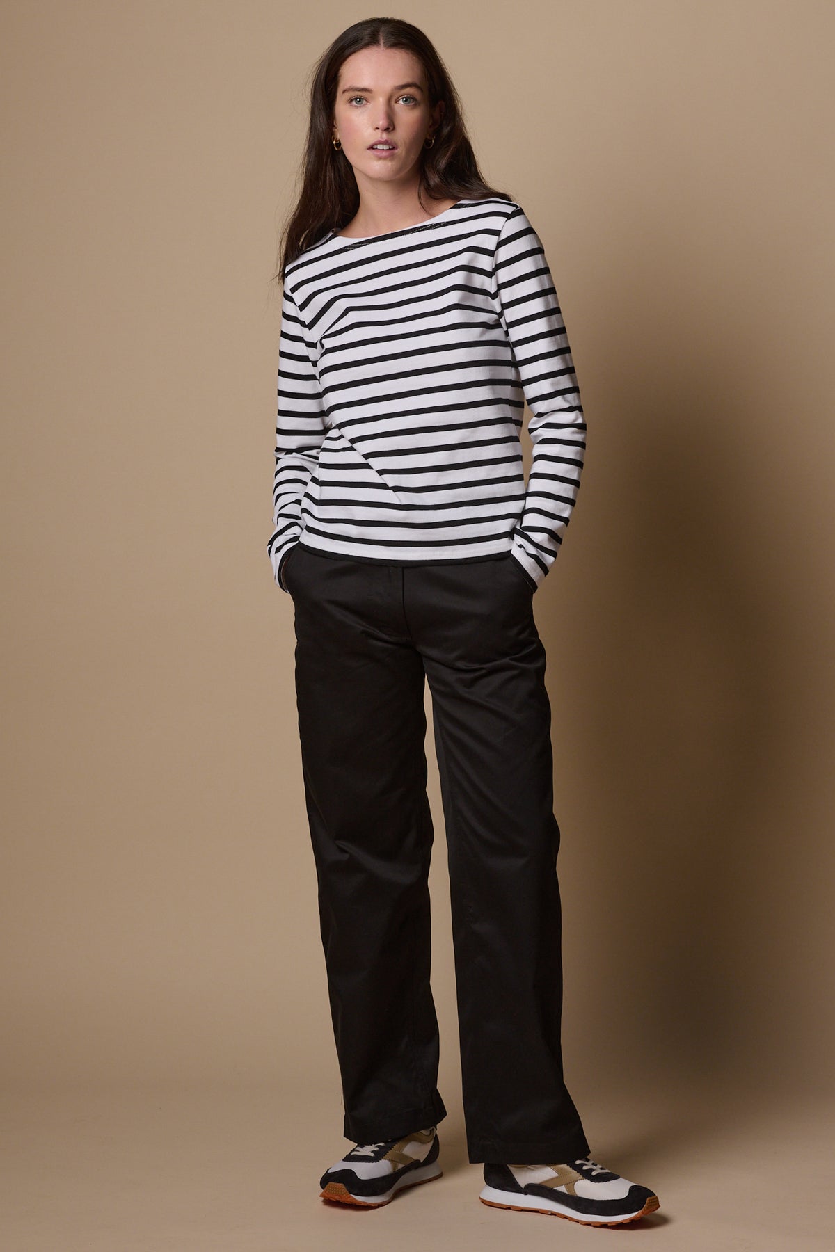 Brunette female wearing work trousers in black, worn with white and black breton