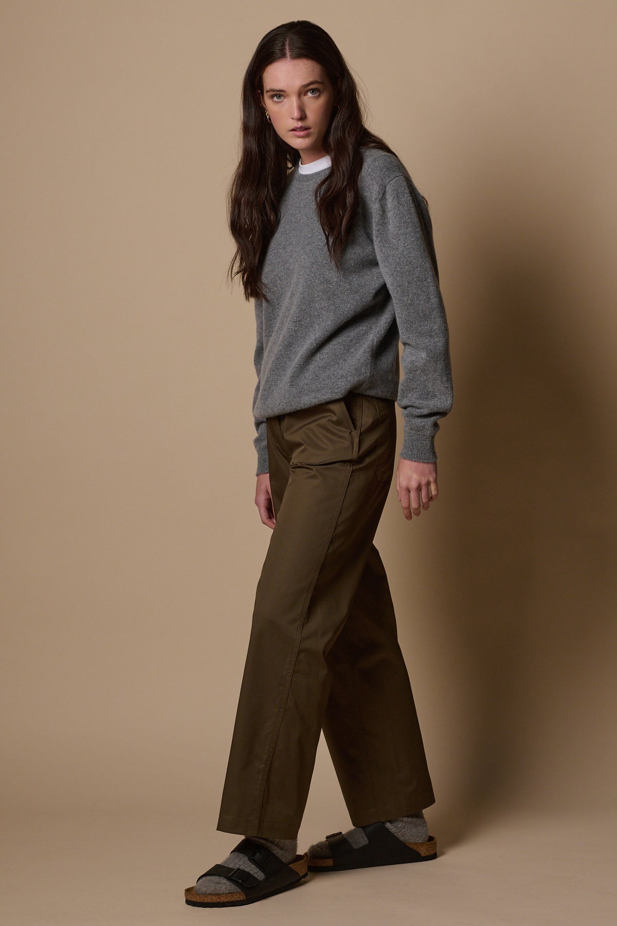 Full body shot of brunette female wearing work trousers in olive