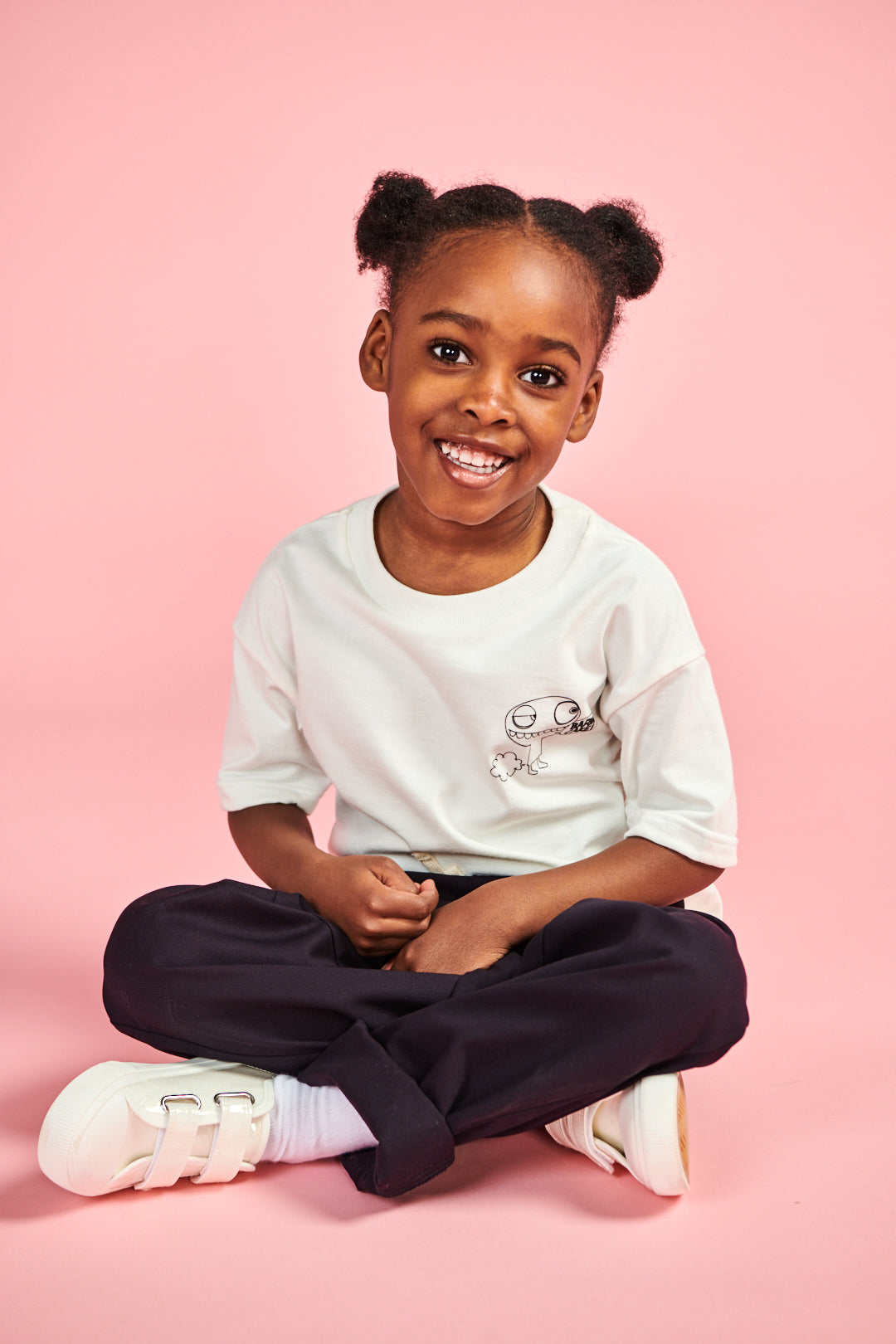 Smiley young girl wearing short sleeve t shirt in bone with barm cake! print on chest