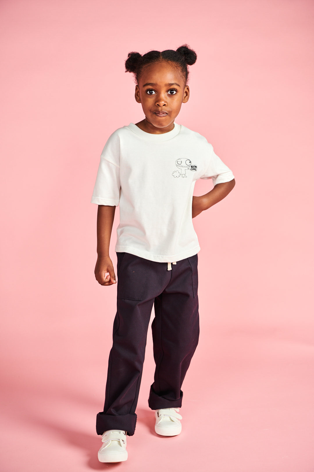 Young girl wearing short sleeve t shirt in bone with barm cake! print on chest