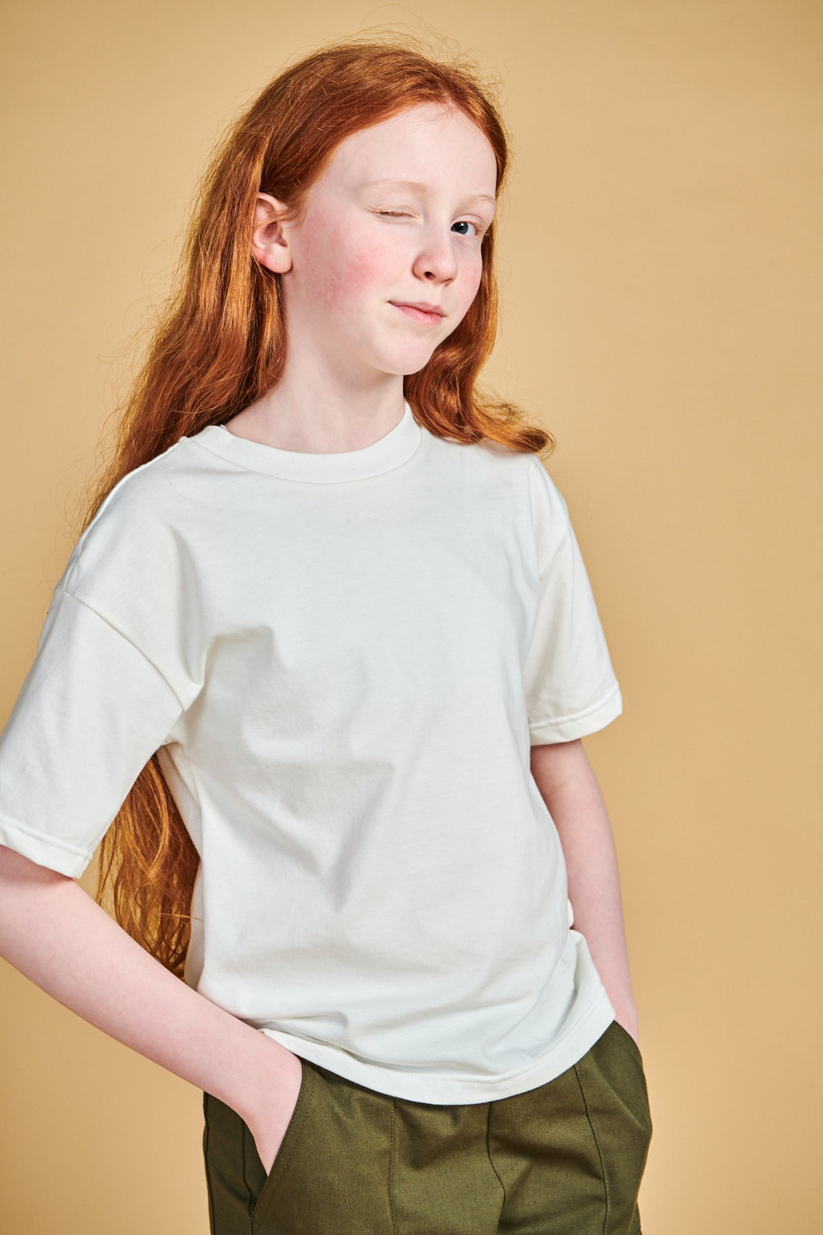 Young girl wearing plastic free short sleeve t shirt in bone