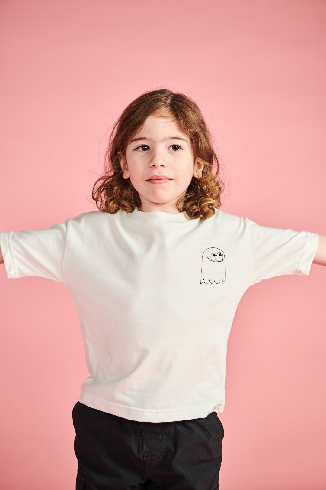 Young boy wearing short sleeve t shirt plastic free in bone with ghost print on chest