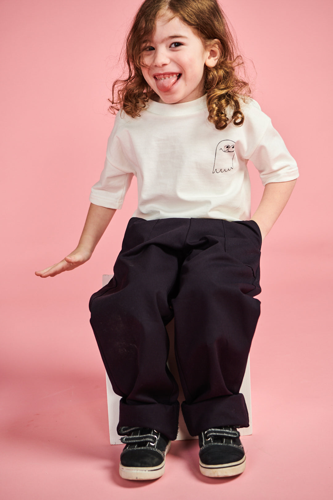 Smiley young boy wearing short sleeve t shirt plastic free in bone with ghost print on chest