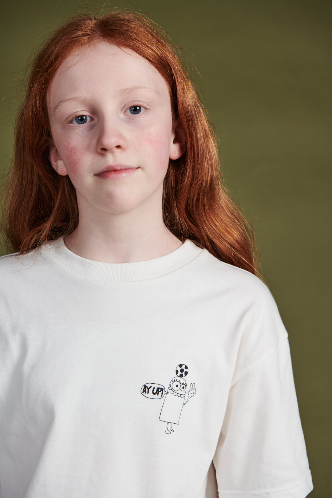 Girl wearing short sleeve t shirt with 'aye up!' pri