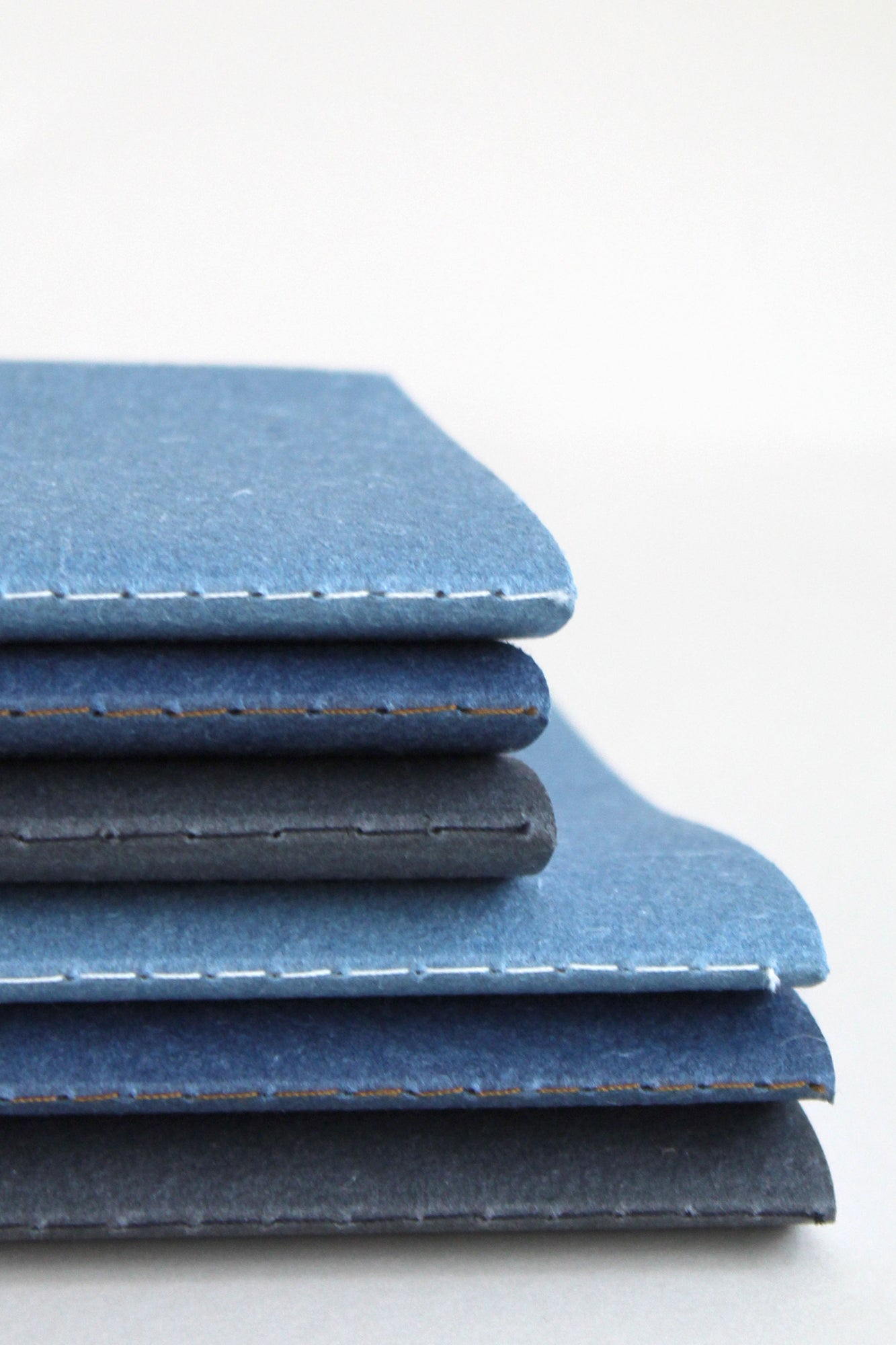 Close up of the notebook set showing 3 colours, blue, indigo and black in both A6 and A5 size