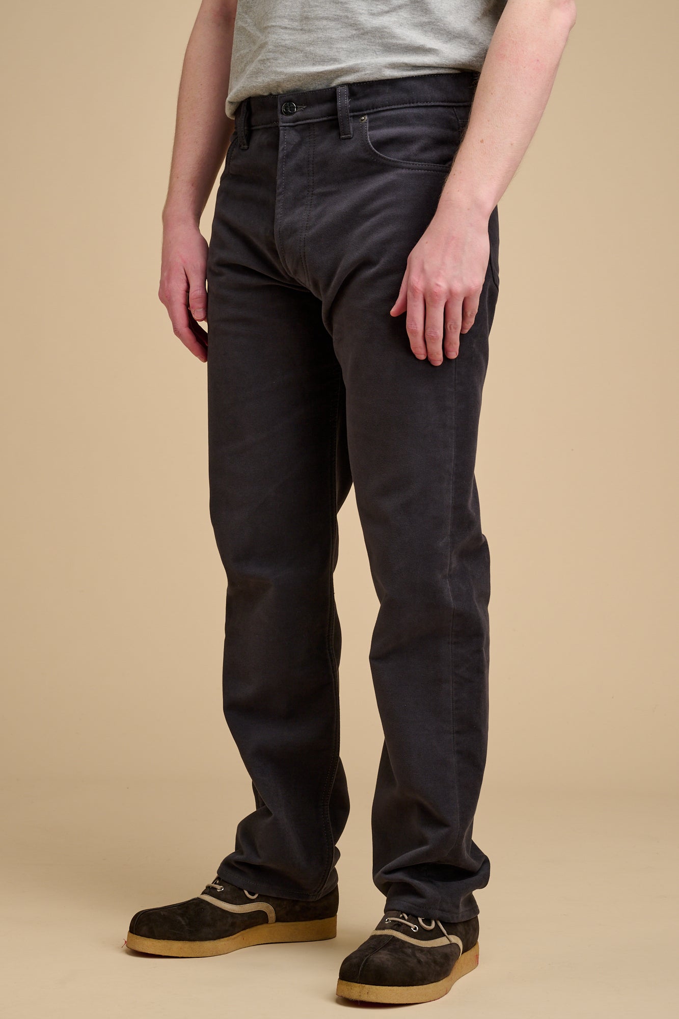 Male wearing moleskin jeans in slate grey.