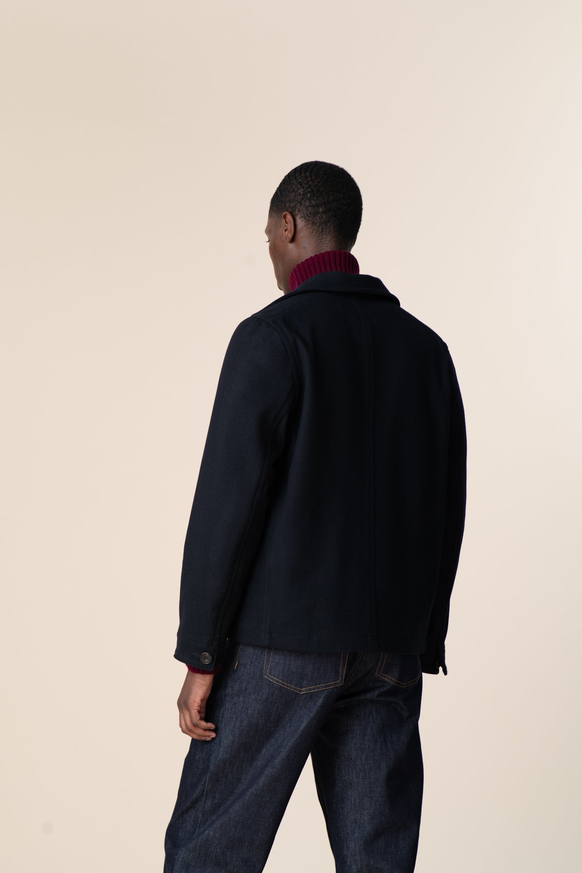 Image of the back of black male wearing Arthur Jacket in navy.