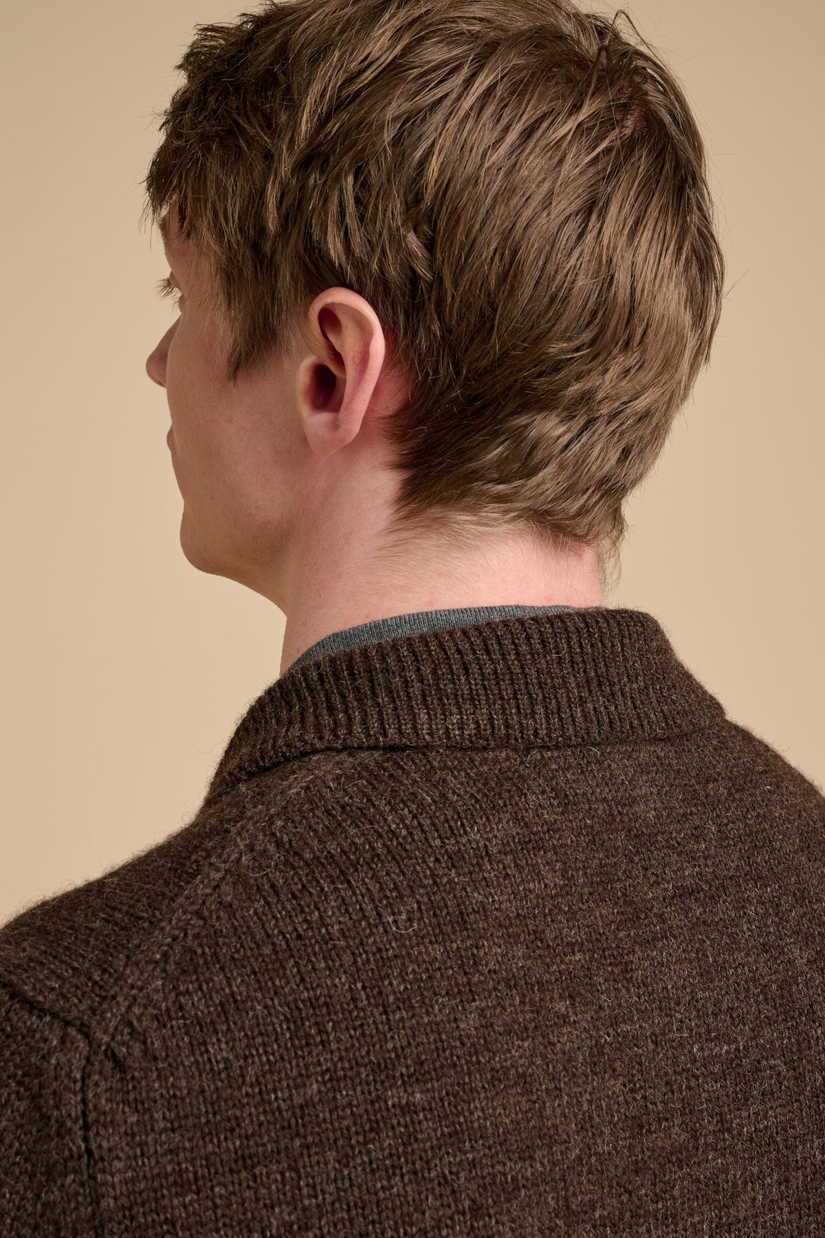Close up of the back collar of brown knitted cardigan