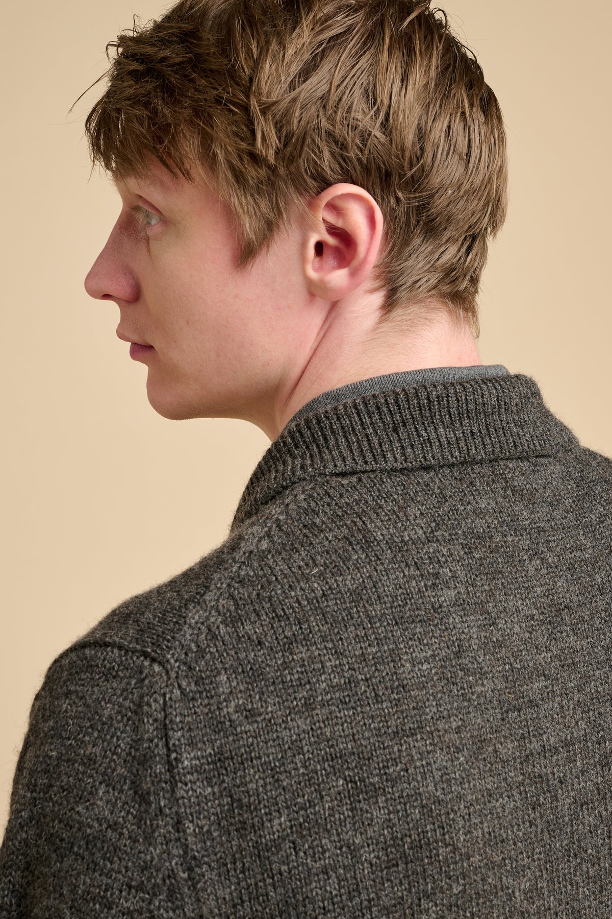 The back of man wearing grey cardigan