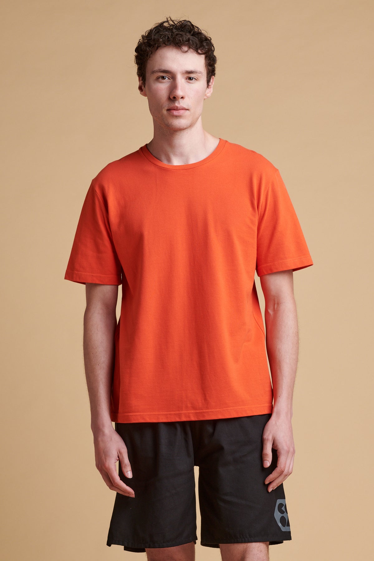 Male wearing breathable t shirt in flame red.