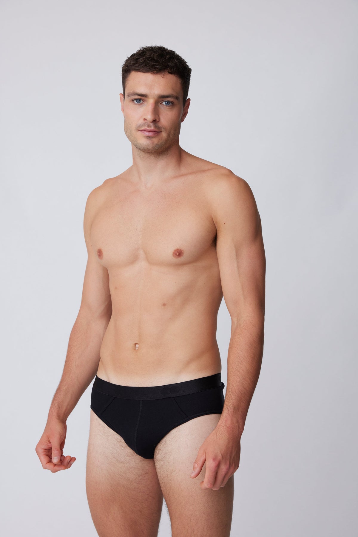 
            White, brunet male wearing only black brief 