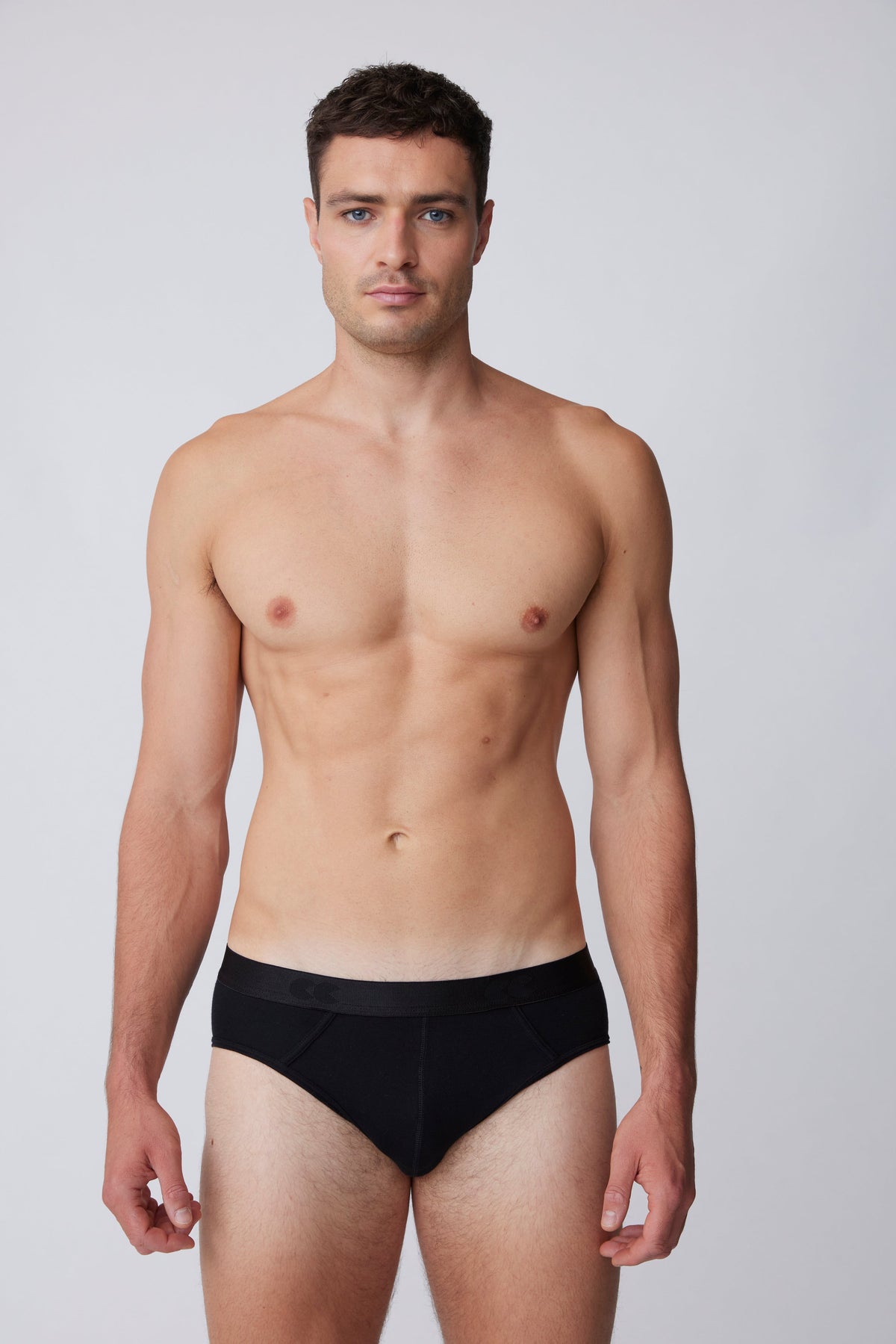 
            White, brunet male wearing only black brief