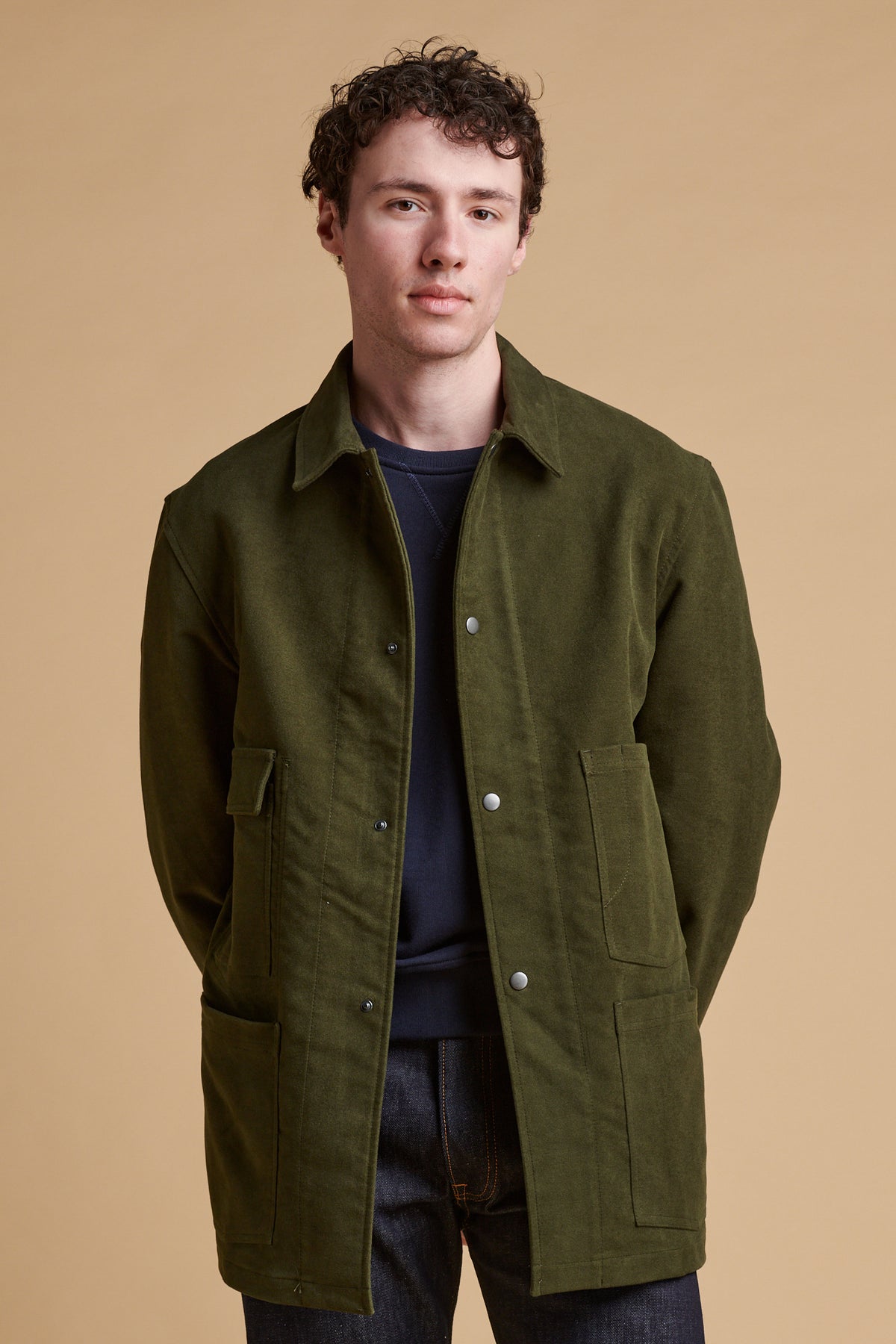 Male wearing Carter moleskin chore jacket in dark olive.