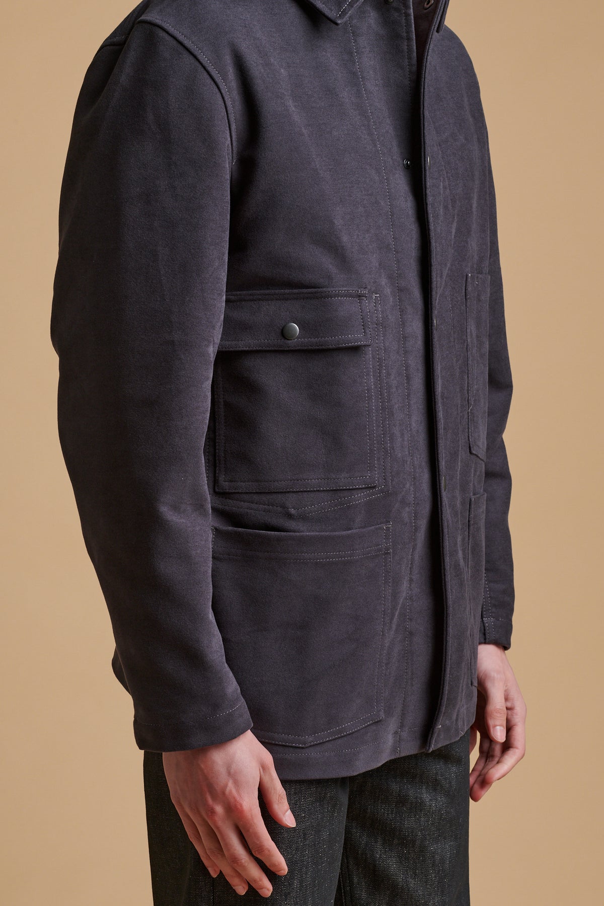 details of the front pockets on men's wearing Carter moleskin chore jacket in slate.