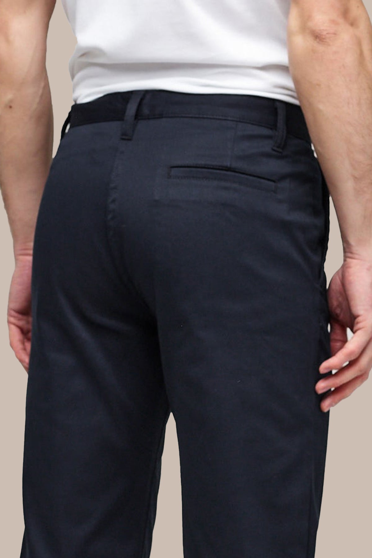 
            Detail of back pocket and belt loops on waistband of Men&#39;s Slim Stretch Chinos in navy.