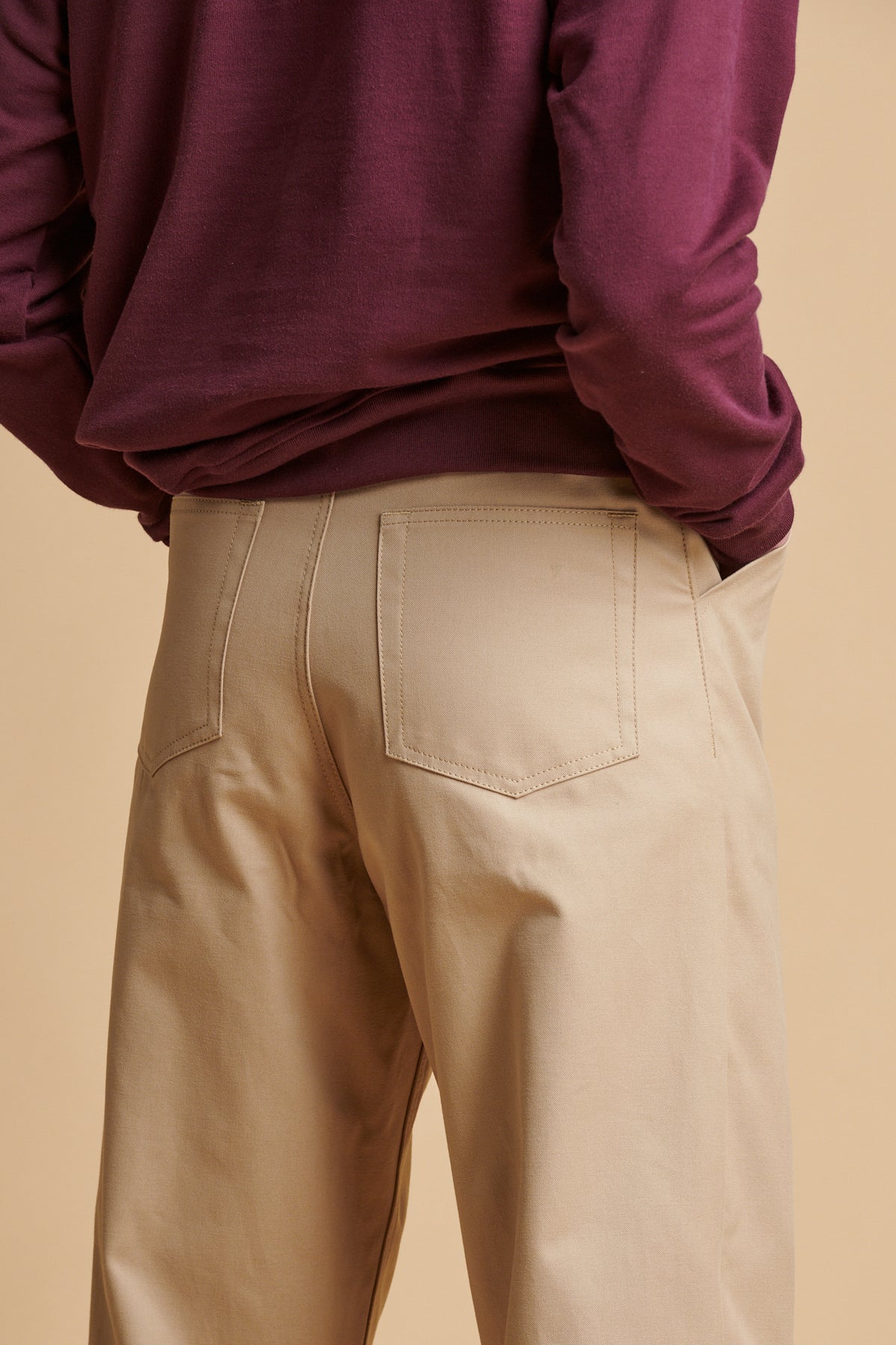 The back of male wearing chore heavyweight canvas trousers in putty.