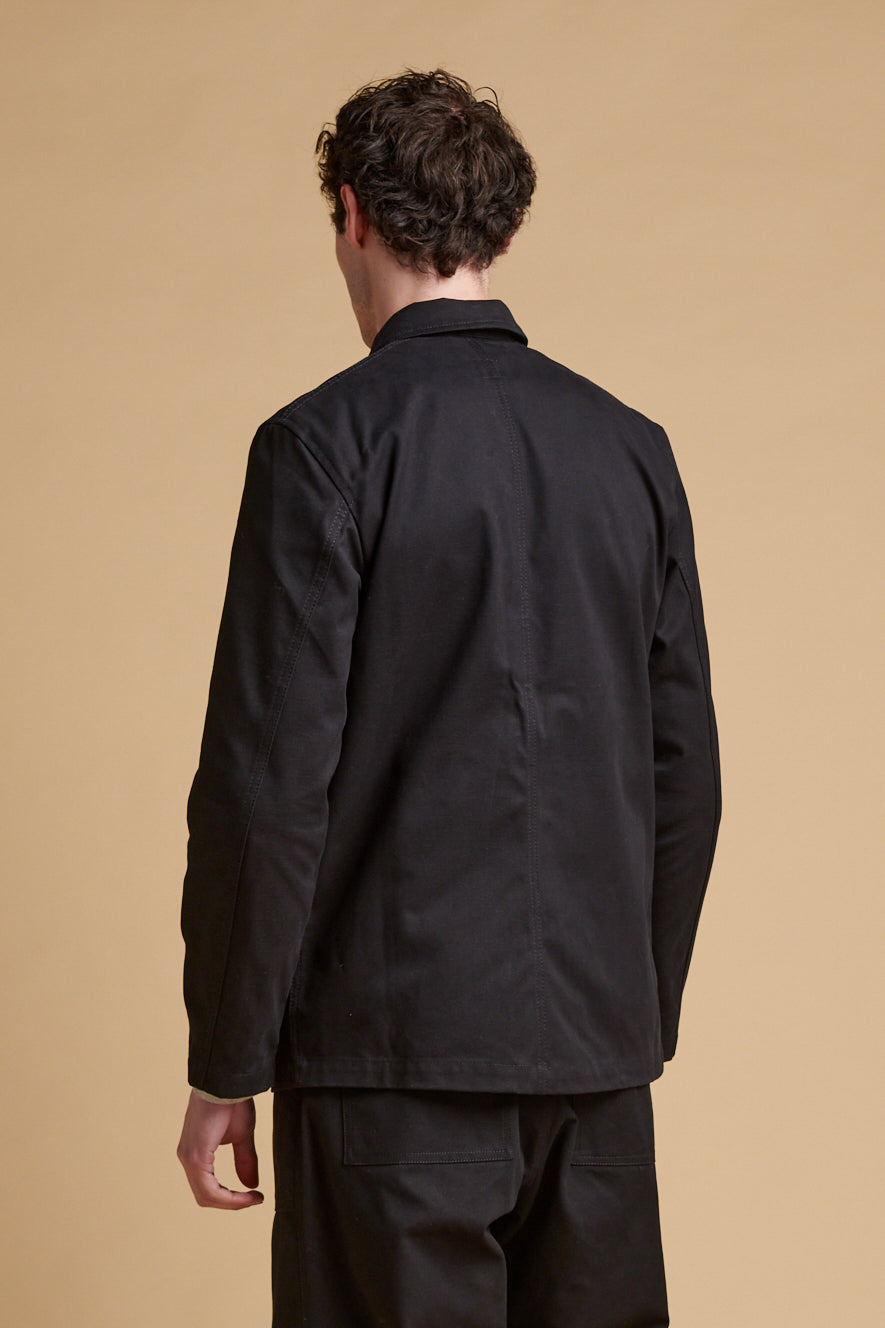 The back of male wearing chore jacket black.