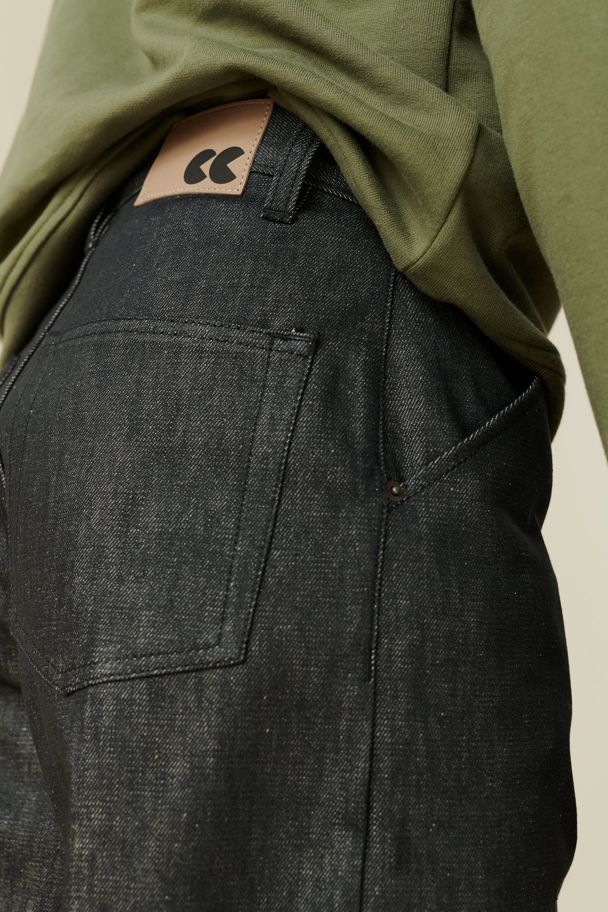 Back pocket and CC logo jean patch detail of men's chore jeans in black.