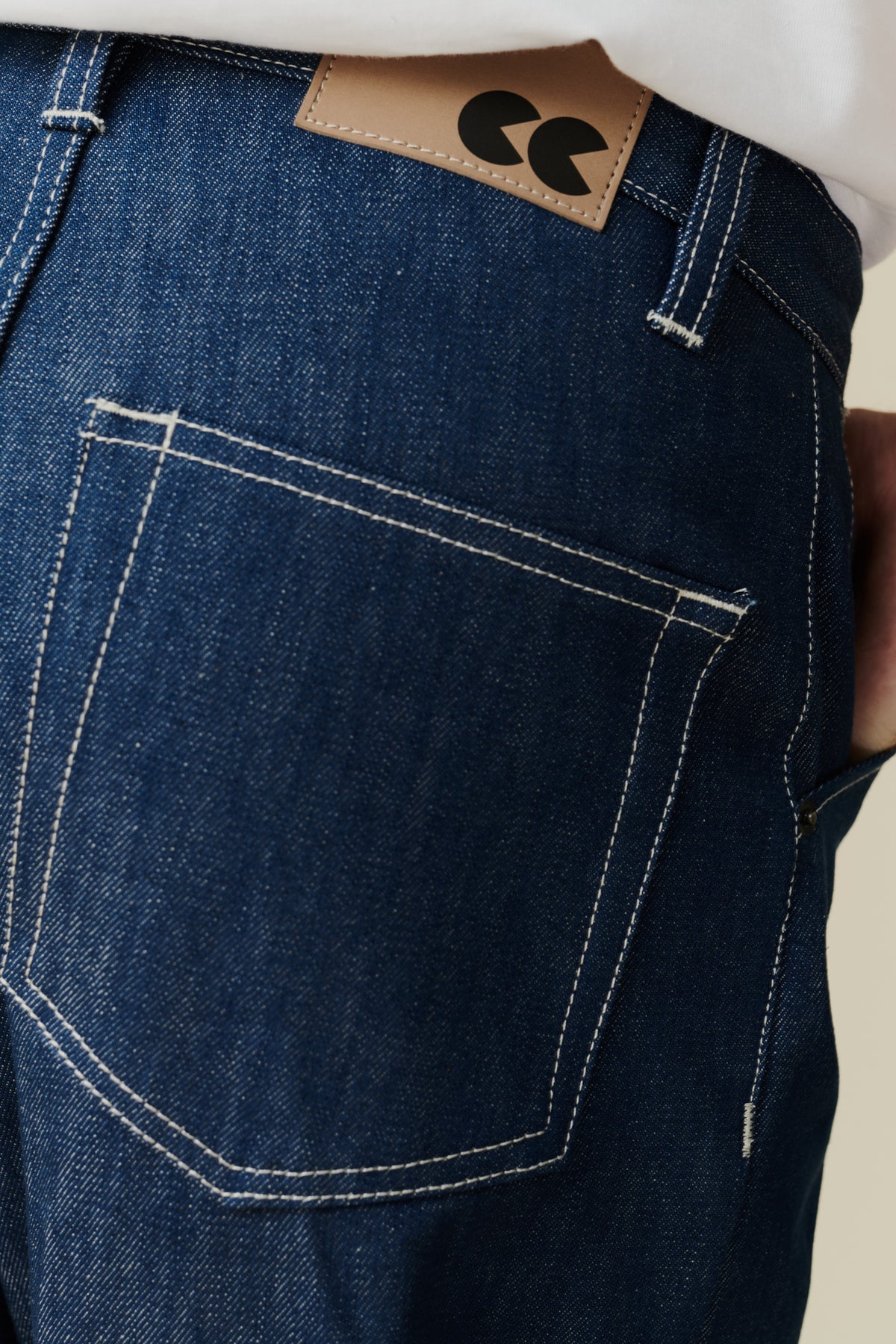 
            Back pocket detail of chore jean in blue, belt loops and jean belt