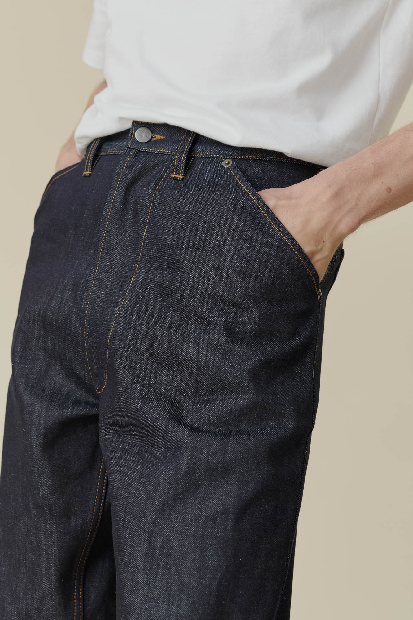 Front pocket detail shot of male in chore jean indigo