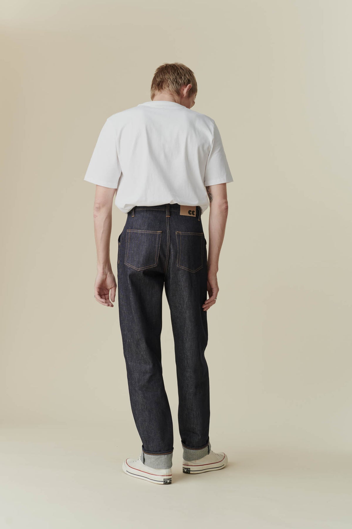 Full body back shot of male in chore jean indigo